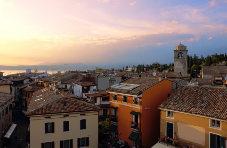 Early evening view of Sirmione in the warm light of the sunset with Lago di Garda at the background.の写真素材