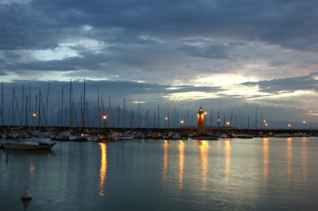 Just before the sunrise at Desenzano del Garda with the Marina and the old lighthouse.の写真素材