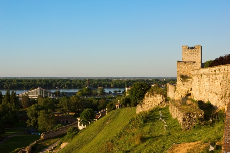 Belgrade panoramic view toward Danube river from Kalemegdan park with fortress walls lit by the setting sun.の写真素材