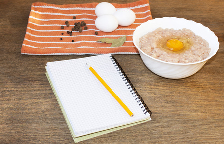 Chopped meat with eggs and spices on the table. Recipe.の写真素材