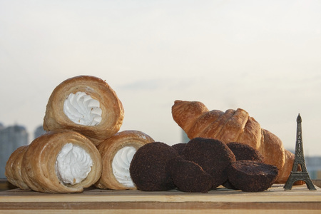 French homemade pastries and sweets: croissant, tubes with cream, truffles.の写真素材
