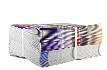 Pile of bundled magazines isolated on white background