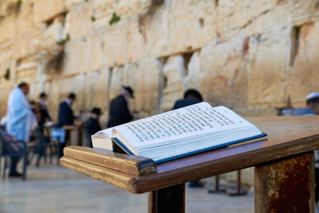 Western Wall also known as Wailing Wall in Jerusalem. The Bible Book in the foreground. Western Wall also known as Wailing Wall in Jerusalem. The Bible Book in the foreground.