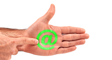Man clicks email  at symbol button on his open palmの写真素材