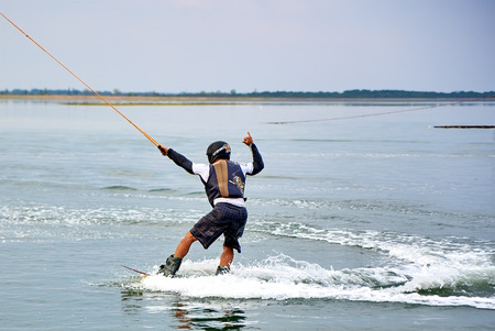 Lazurne, Ukraine - August 23, 2015: Wakeboarder shows extreme trick at the youth festival "Crazy People" of sport and music on the Black Sea beach. The festival gathers a lot of people and celebritiesのeditorial素材