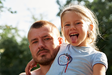Father plays with his little daughterの写真素材