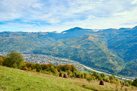 Mountain country village landscape with clouds and blue sky. Alps.の写真素材