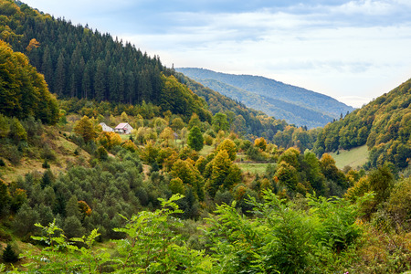 Mountain country village landscape with clouds and forest. Alps.の写真素材
