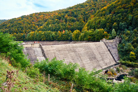 Weir and dam in the canyon between mountainsの写真素材