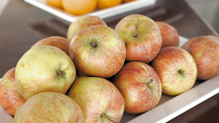 Fresh applle fruits on breakfast in a restaurant. Enjoying sweet fruits on summer vacation. Healthy food conceptの写真素材