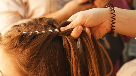 Female model getting her hair dressed before an event. Makeup appearance and hairstyle are important...