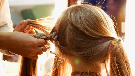 Female model getting her hair dressed before an event. Makeup appearance and hairstyle are important for every beautiful woman.の写真素材
