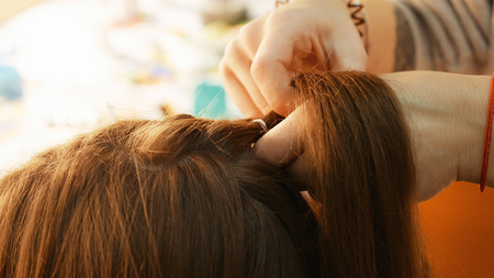 Female model getting her hair dressed before an event. Makeup appearance and hairstyle are important...