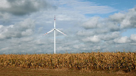 Wind turbine over stormy cloudy sky using renewable energy to generate electrical power. Renewable...
