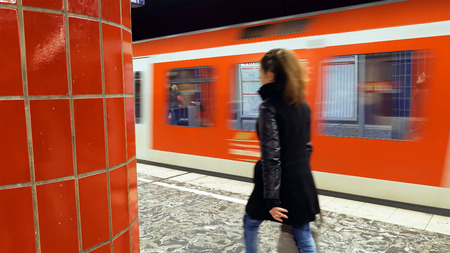 Hamburg, Germany - October, 10, 2016: People at subway metro underground tube station walk to get the arriving train. Passengers use public transportation subway metro system in a big European city.のeditorial素材