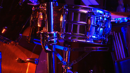 Drum set in the stage in soundlights ready to be played on by drummerの写真素材