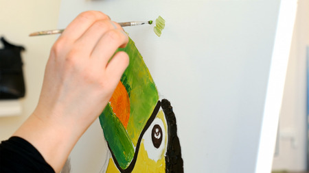 Artist paints a picture oil painting artwork drawing on canvas easel in art studio. Student learning to draw and paint.の写真素材