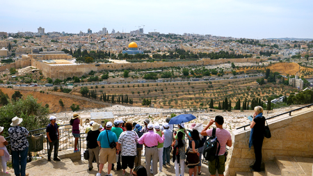 Jerusalem - May 24, 2017: The guide shows the Jerusalem Old City view to the tourists. Mount of Olives is a famous and sacred Christian's place and it has a fantastic view to the Old Jerusalem.のeditorial素材