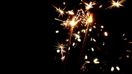 Burning Sparklers in blurred motion. Christmas New Year and Independence Day celebration lights.の写真素材