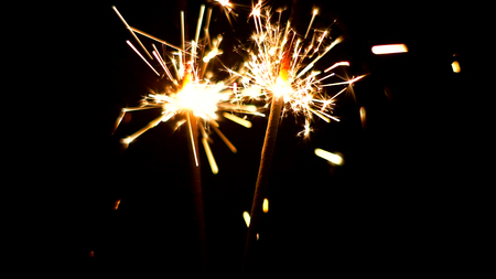 Burning Sparklers in blurred motion. Christmas New Year and Independence Day celebration lights.の写真素材
