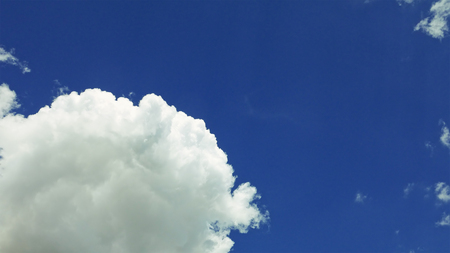 White clouds are moving over the blue sky. Fair weather concept.