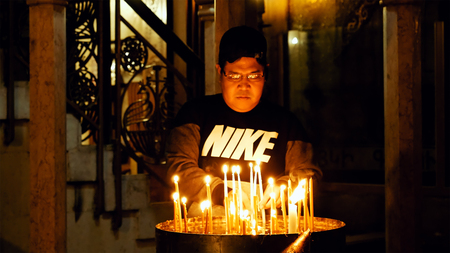 Jerusalem, Israel - May 25, 2017: Prayers lighting candles in the Holy Sepulcher Church in...