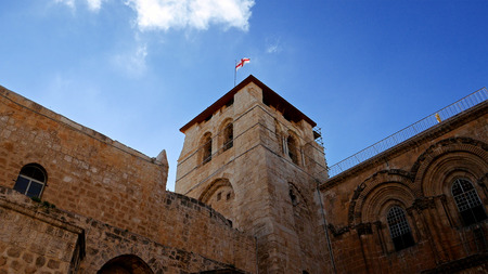Jerusalem, Israel - May 25, 2017: Roof of the Holy Sepulcher Church in Jerusalem with flying flag. The Holy Sepulchre Church and Empty Tomb the most sacred places for all religious Christians in the world. Calvary also located there.のeditorial素材