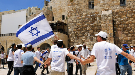 Jerusalem, Israel - May 25, 2017: Jews dancing in a round with flag celebrating the Jerusalem Day at...