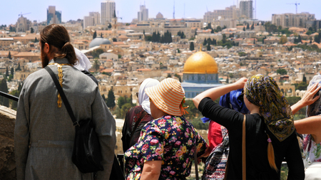 Jerusalem, Israel - May 25, 2017: The Christian orthodox guide shows the Jerusalem Old City view to the pilgrims and tourists from the Mount of Olives. Famous Holy Land place and fantastic city view.のeditorial素材