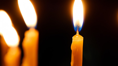 Burning candles in the Holy Sepulcher Church in Jerusalem. The Holy Sepulchre Church and Empty Tomb are the most sacred places for all religious Christians in the world.の写真素材