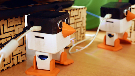 Toy automatic robots are dancing on the table. Robotics and artificial intelligence come to human's life quickly.の写真素材