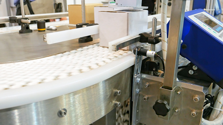 Food factory automated robotic machine. Conveyor product line for cooking and packing rations and food packs. Robotics and automatic lines used instead of human labor on factories and plants.の写真素材