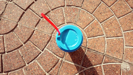 Paper cup with blue sealing cap and red drinking straw.の写真素材