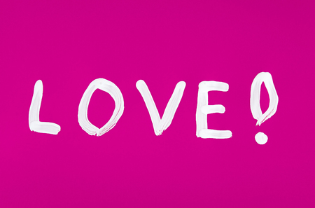 Love word painted on the pink backgroundの写真素材