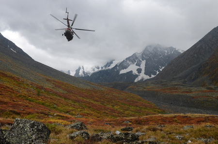 Rescue helicopter over mountains. Altai Republic, Russiaの写真素材