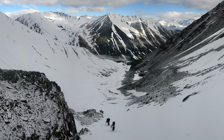 A group of mountain climbers climp up to Mettalurg Peak. Altai Republic, Russiaの写真素材