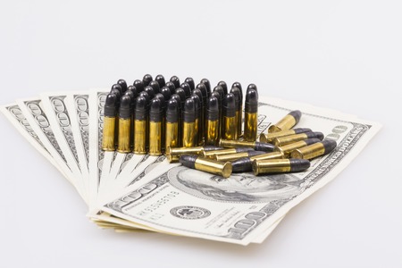 ammunition from the gun on 100 dollar billsの写真素材