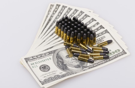 ammunition from the gun on 100 dollar billsの写真素材