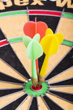 Three darts in the target center dartboard
