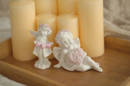 White angel statue. A statuette with a heart.