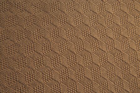 Brown knitted fabric texture. Product from wool. Handworkの写真素材