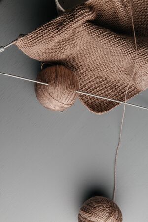 Winter needlework. Wool yarn balls for hand-knitting and knitting spokes on. The place for the text....