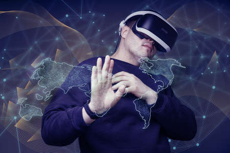 man touches the virtual world with the help of virtual reality glasses. concept of the future....