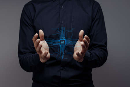 Businessman holds the AI. Concept of modern computer technologies, data mining. Hands touch the...