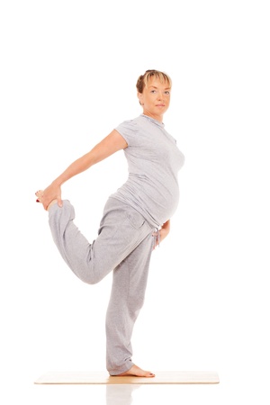 Feature mother doing gymnastic exercises on isolated white background. の写真素材