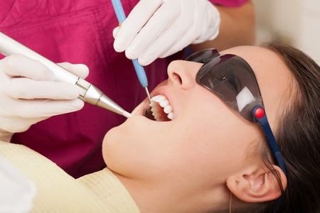 Dentist is checking patient's teethの写真素材