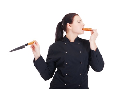 Chef is eating doughnut while cookingの写真素材