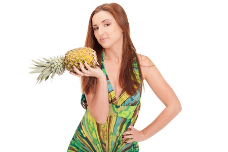 Girl in pineapple-like dress with pinapple in handsの写真素材