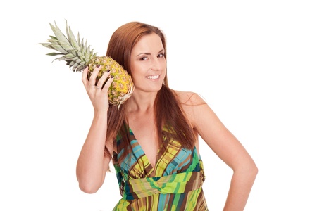 Girl in pineapple-like dress with pinapple in handsの写真素材