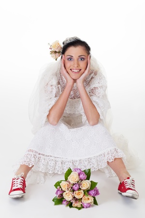 Smiling bride in sneakers looking at cameraの写真素材